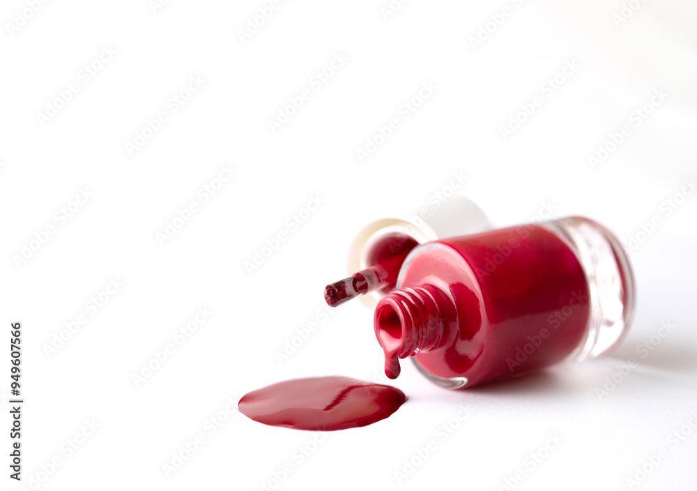 Red color polish nail pouring from bottle to white background for for beauty advertising and visual content Red color polish nail pouring from bottle to white background for for beauty advertising and visual content