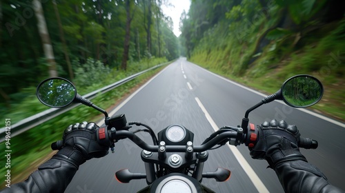 View from a motorcyclist's perspective riding on an open road through a lush green forest, symbolizing freedom and adventure. photo