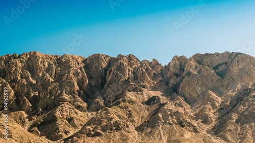 high rocky mountains against a clear blue sky