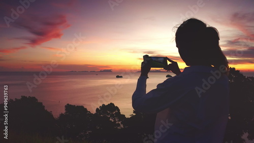 Wallpaper Mural Woman silhouette stand on hill make photo colorful evening seascape scene. Person enjoy dramatic beautiful ocean sunset sky. Travel to Thailand, summer vacation. Lifestyle holiday concept. Back view Torontodigital.ca