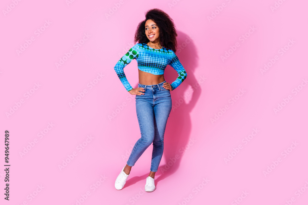 Full body photo of attractive young woman posing look empty space dressed stylish blue clothes isolated on pink color background Full body photo of attractive young woman posing look empty space dressed stylish blue clothes isolated on pink color background
