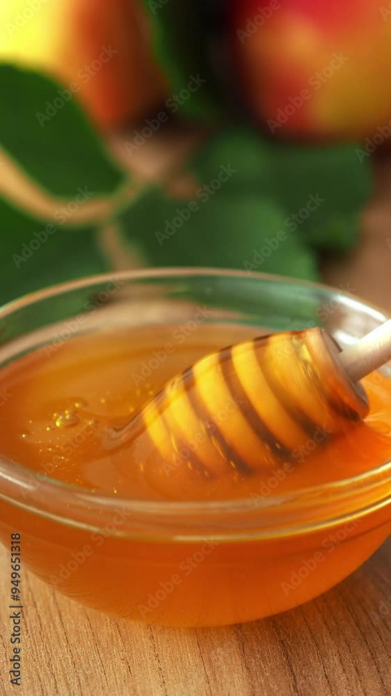 Collect honey with a wooden spoon with a spindle. Natural fresh floral honey in a saucer close-up. Beekeeper's Day, Honey Bee Day. Golden liquid honey of fresh harvest. Collect honey with a wooden spoon with a spindle. Natural fresh floral honey in a saucer close-up. Beekeeper's Day, Honey Bee Day. Golden liquid honey of fresh harvest.