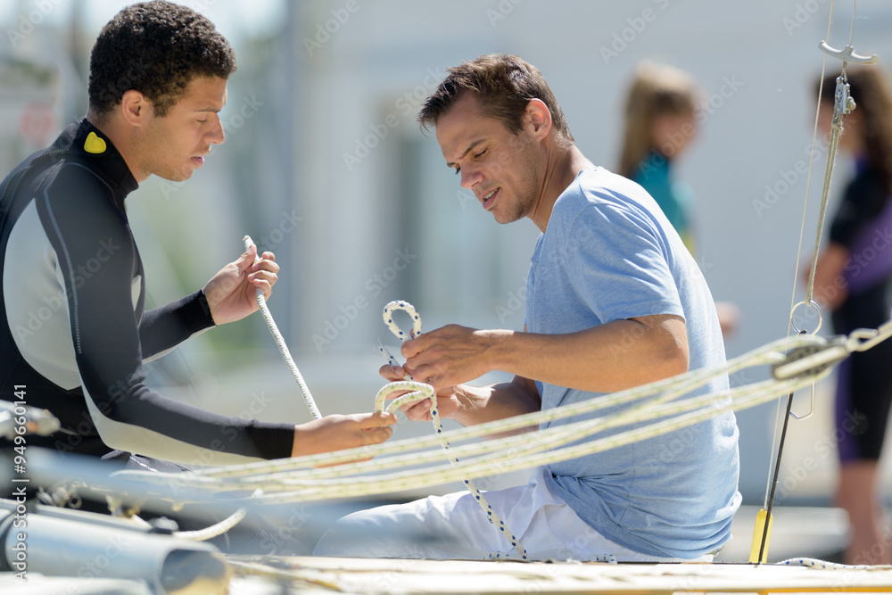 Fototapeta premium two man drive a sport sailing yacht in competition