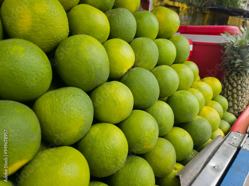 Close up shot of Mosambi fruit which is also know as Sweet Lemon in fruit seller cart. photo