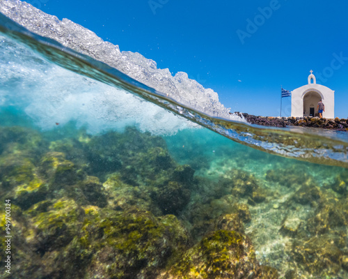 Small white church Saint Nikolaos in the sea, Georgioupoli, Crete, Greece.