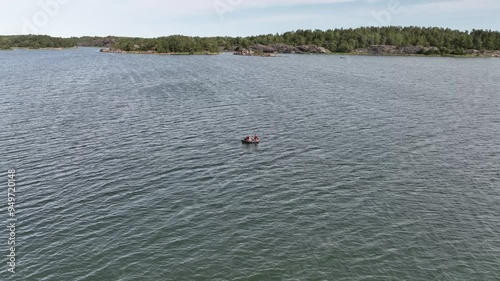 Fishing and boating through waters in Sweden among deserted islands in summer