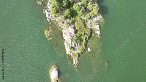 Top view of a deserted island with rocks and forest in Sweden during summer