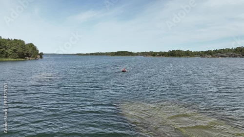 Fishing and boating through waters in Sweden among deserted islands in summer
