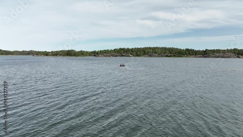 Fishing and boating through waters in Sweden among deserted islands in summer