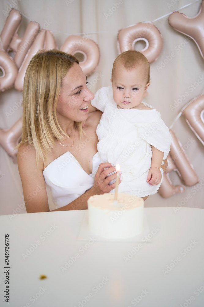 baby girl tries her first birthday cake with mom and pre-teen sister baby girl tries her first birthday cake with mom and pre-teen sister