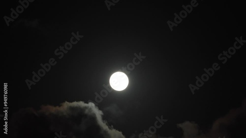 Full moon and moving clouds at night. Mystery or scary or halloween concept 4k video.