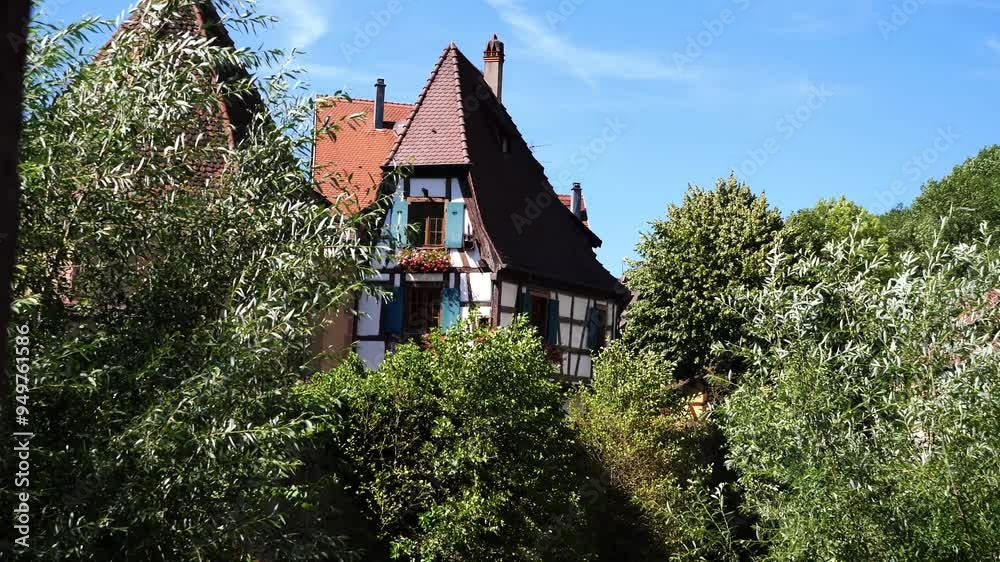 Alsace, France, an house is surrounded by trees and bushes Alsace, France, an house is surrounded by trees and bushes