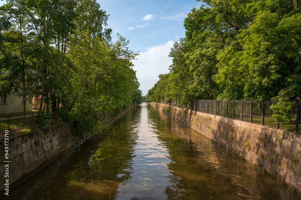View of the Obvodny (Admiralteysky, Wired) Canal along Sovetskaya Street on a sunny summer day, Kronstadt, St. Petersburg, Russia View of the Obvodny (Admiralteysky, Wired) Canal along Sovetskaya Street on a sunny summer day, Kronstadt, St. Petersburg, Russia