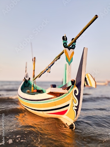 The boat is parked at the edge of the beach