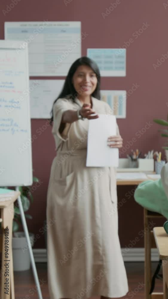 Full vertical shot of cheerful Hispanic female teacher asking questions to class during English or foreign language lesson, to check knowledge of grammar Full vertical shot of cheerful Hispanic female teacher asking questions to class during English or foreign language lesson, to check knowledge of grammar