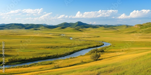 A large, open field with a river running through it. The sky is clear and blue, and the sun is shining brightly. The scene is peaceful and serene, with the river providing a calming background