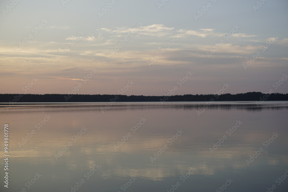 Amazing magical sunset on a forest lake. Quiet evening. Reflection on the surface of the water. Amazing magical sunset on a forest lake. Quiet evening. Reflection on the surface of the water.