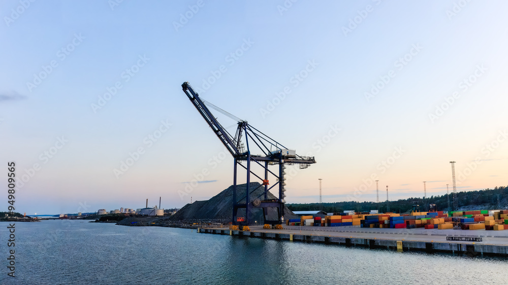 Container crane at a harbor at sunset. Ideal image for themes related to global trade, industrial operations, and shipping logistics. Copy space Container crane at a harbor at sunset. Ideal image for themes related to global trade, industrial operations, and shipping logistics. Copy space