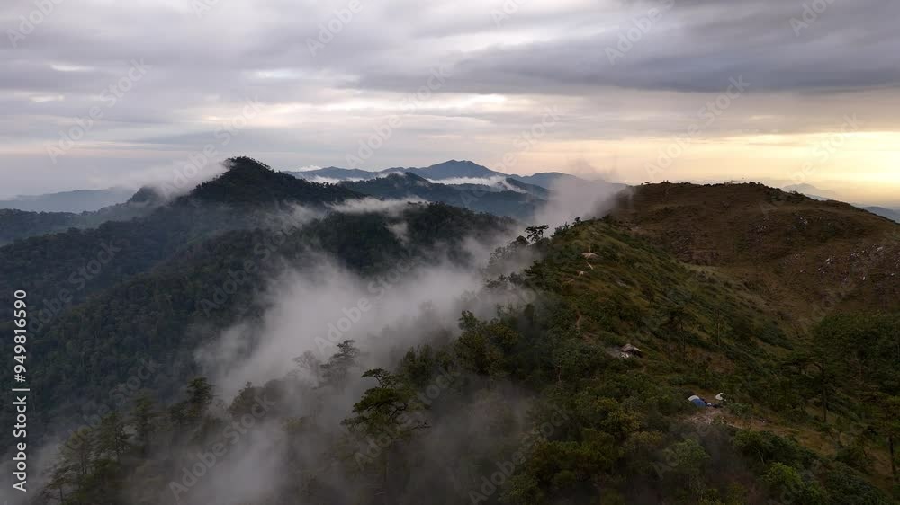 Drone flying over sea of mist and mist in forest-covered mountains at sunrise. Drone flying over sea of mist and mist in forest-covered mountains at sunrise.