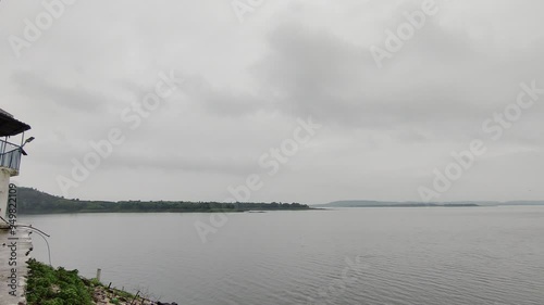 Footage of landscape scene of a lake, hills, trees shot against a cloudy sky. Scenic view from Mahi Dam at Banswara
 photo