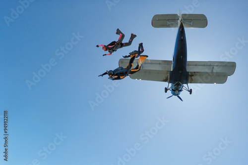 Three skydivers jump out of the plane