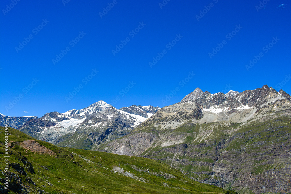 Swiss Alps peaks and ridges covered in snow in Summer. Swiss Alps peaks and ridges covered in snow in Summer.