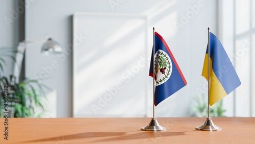 FLAGS OF BELIZE AND UKRAINE ON TABLE photo