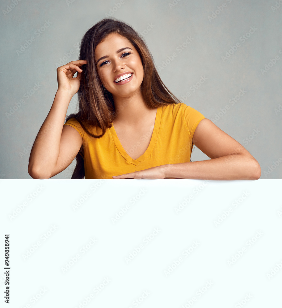 Confident, portrait and woman with poster in studio for billboard, design and advertising information. Person, smile and banner with mockup space for promotion, sign and marketing on gray background Confident, portrait and woman with poster in studio for billboard, design and advertising information. Person, smile and banner with mockup space for promotion, sign and marketing on gray background