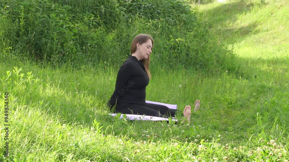 Woman makes yoga exersices outdoor. Healthy lifestyle activity in the park at the morning Woman makes yoga exersices outdoor. Healthy lifestyle activity in the park at the morning