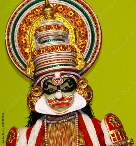 MUNNAR, INDIA - FEBRUARY 10, 2016: Undentified Artist / Kathakali dancer in Red Attire in Munnar of Kerala's state in India. Face Closeup and showing his necklace and face painted. photo