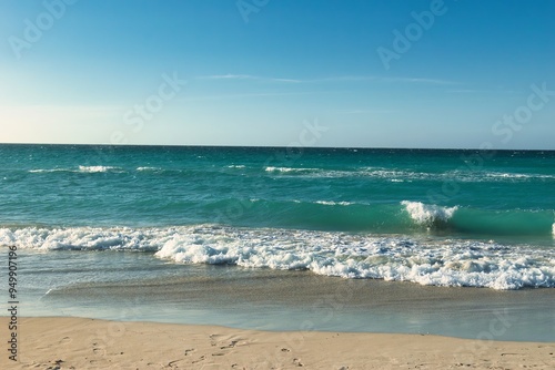 Varadero, CUBA - April 08, 2023: Wide angle shot of beautiful beach on a hot summer day in the Caribbean, in Varadero, Cuba. Empty beach, calm sea.