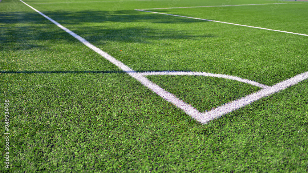 Obraz premium Artificial football turf with a white dividing line. Texture of Perfect green lawn on the football field. 