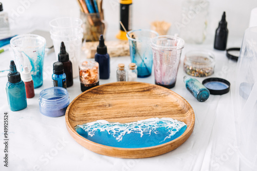 Creating stunning epoxy resin art with vibrant colors and textures for a coastal-themed serving tray at a DIY workshop photo