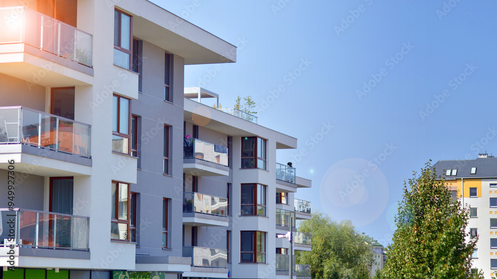Obraz premium A apartment building with a lot of balconies and windows. The building is surrounded by trees and has a lot of greenery. Green surroundings of buildings. Ecological housing estate.