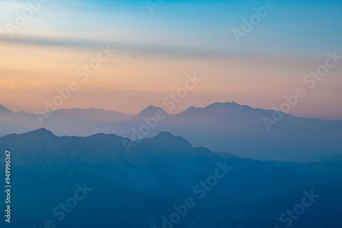 Silhouettes of mountains in a beautiful gentle haze, mountains at sunset or sunrise, natural background