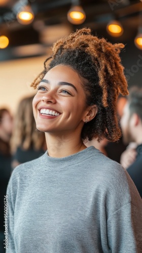 A group of adults at a casual social event, with one person turning to the camera with a joyful expression while others continue their conversations, capturing the essence of spontaneous connection