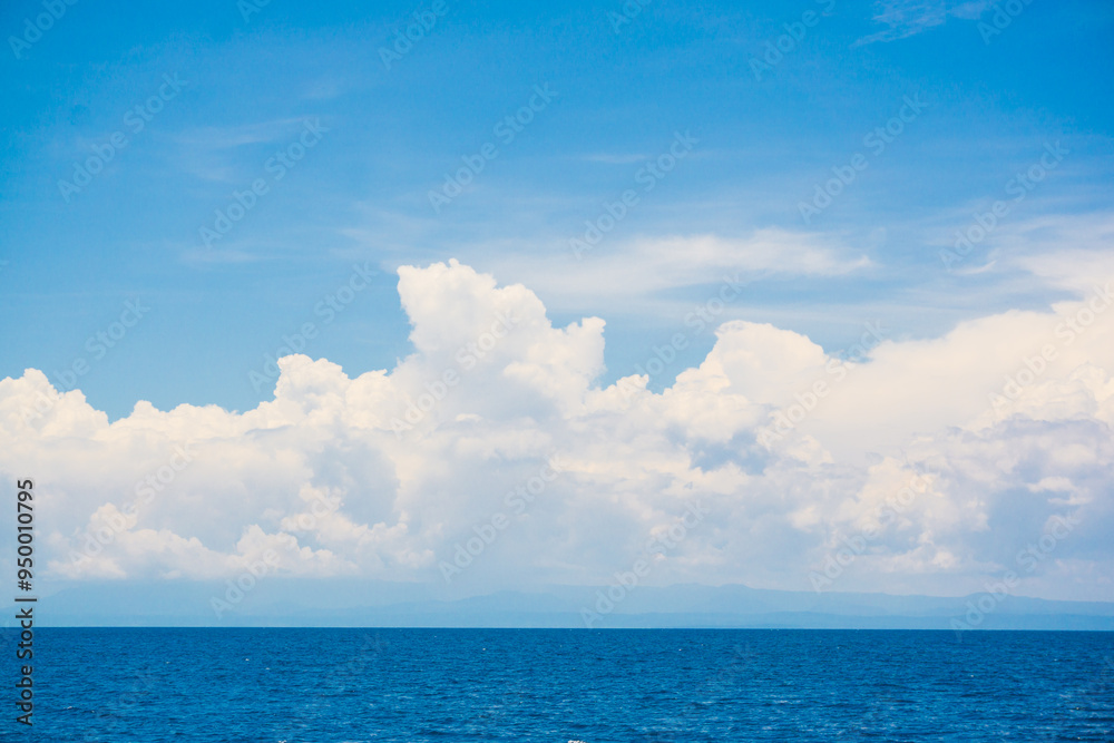 Blue sky with fluffy cloud in sea background Blue sky with fluffy cloud in sea background