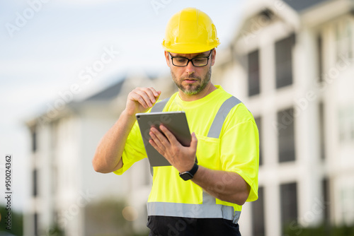 A construction worker in highvisibility gear emphasizes safety and professionalism at a dusty work site photo