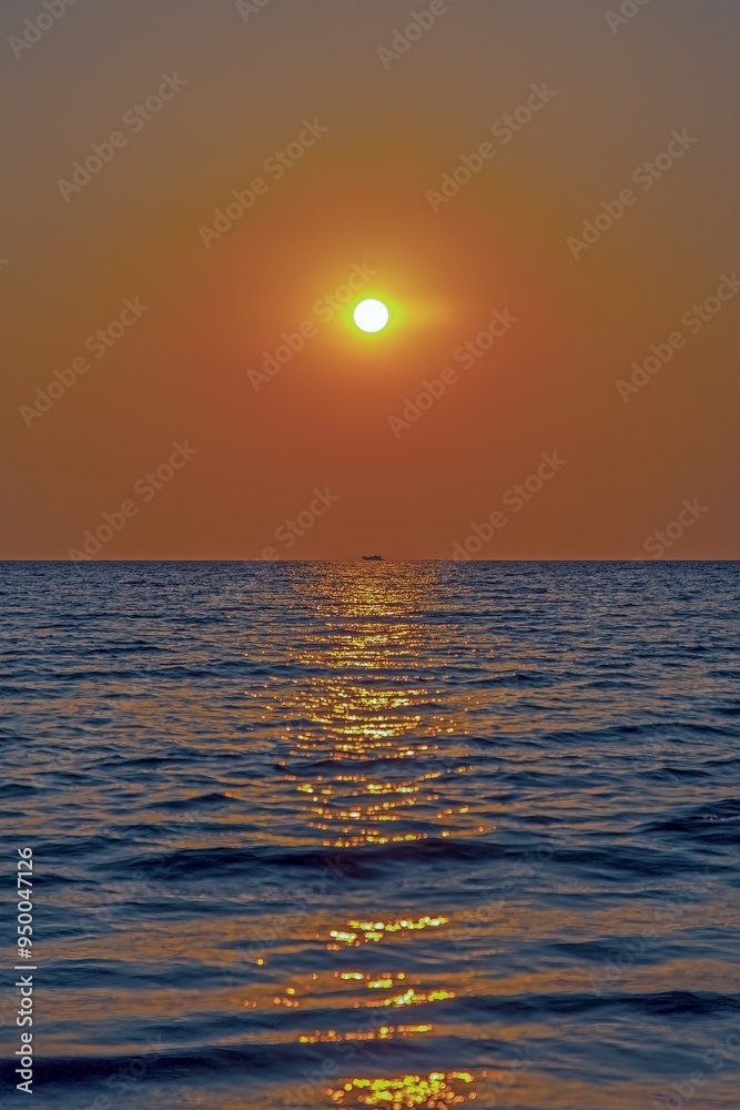 Picture of a sailing yacht on the sea in front of the setting sun in back light Picture of a sailing yacht on the sea in front of the setting sun in back light