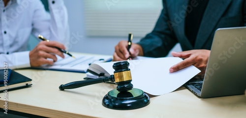 Tableau sur toile Two lawyers consult in a modern office, presenting compelling arguments and demonstrating their expertise, trying to win a case with their legal acumen and persuasive skills