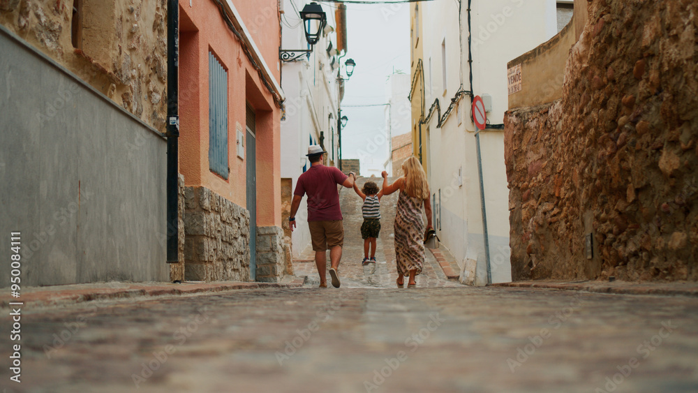 parents walking their son