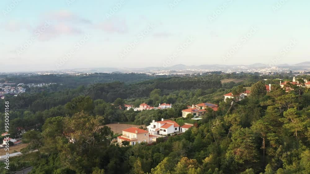 Aerial view of Sintra's mountainous landscape with houses nestled in green surroundings. Video captures peaceful blend of urban living and nature Aerial view of Sintra's mountainous landscape with houses nestled in green surroundings. Video captures peaceful blend of urban living and nature