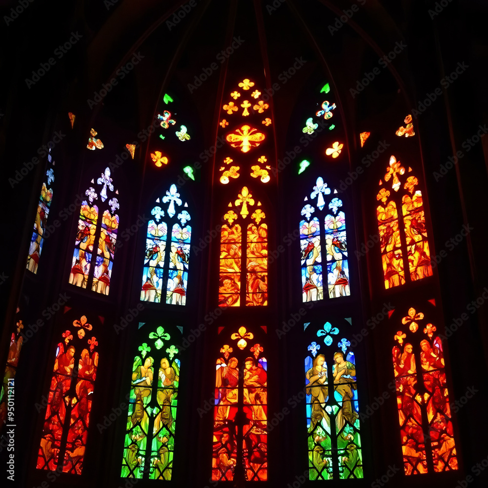 A stunning display of stained glass windows, showcasing intricate designs and vivid colors that illuminate the interior of a historic cathedral. The vibrant light creates a mesmerizing play of color a A stunning display of stained glass windows, showcasing intricate designs and vivid colors that illuminate the interior of a historic cathedral. The vibrant light creates a mesmerizing play of color a