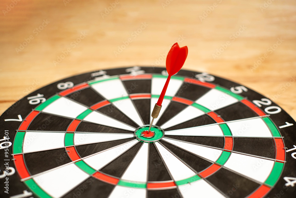 Red dart in the middle of the target. Concept of targeting online marketing. Setting goals to match your business. Planning and setting goals in life.. Red dart in the middle of the target. Concept of targeting online marketing. Setting goals to match your business. Planning and setting goals in life..