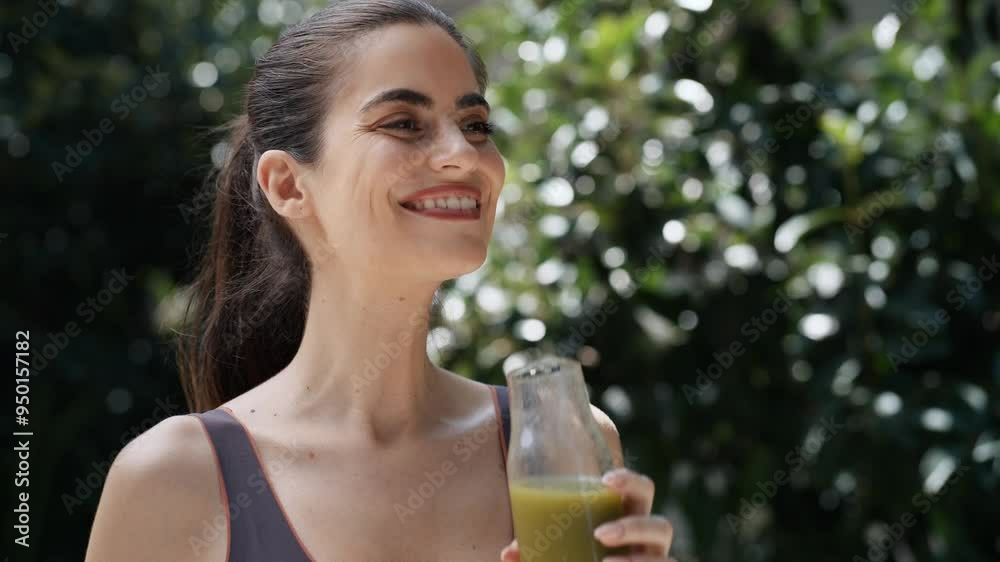 Video of healthy young woman drinking detox juice in the garden