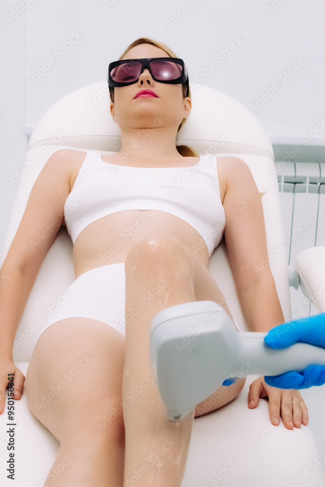 Laser hair removal at a beauty salon: a client relaxes on a sofa. Ideal for showcasing modern care and the effectiveness of the technology. Laser hair removal at a beauty salon: a client relaxes on a sofa. Ideal for showcasing modern care and the effectiveness of the technology.