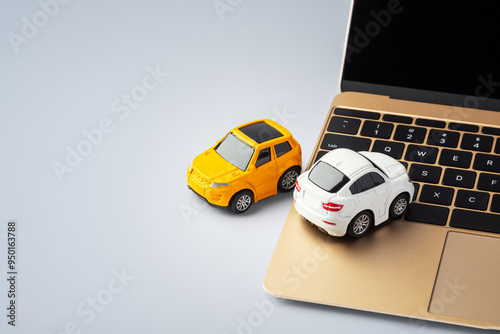 Online car business concept, car toy on laptop on blue table background