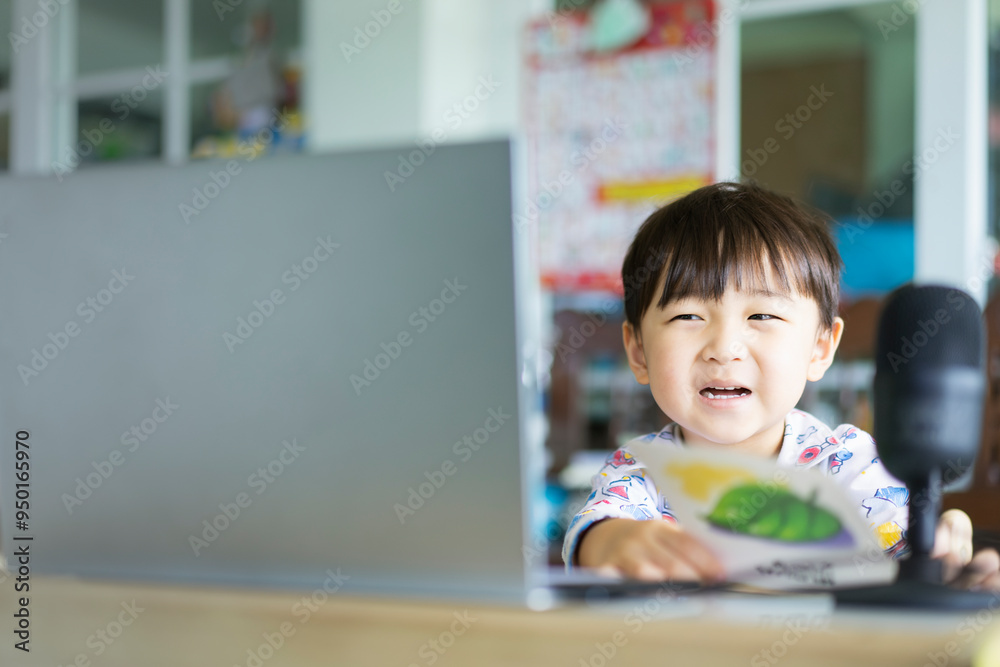 Asian boy studying at home using laptop as medium of communication concept of distance learning, Home School. Asian boy studying at home using laptop as medium of communication concept of distance learning, Home School.