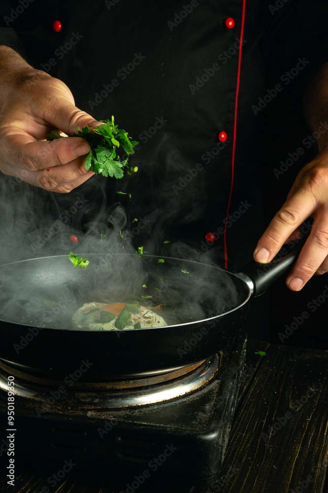 Fototapeta premium A cook adds chopped greens to a frying pan with eggs by hand. Concept of making fried egg for breakfast.
