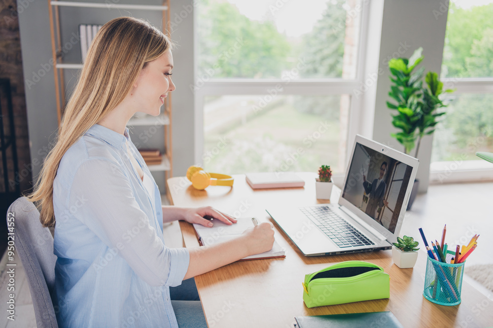 Photo of adorable sweet lady wear blue shirt writing copybook distance education modern device indoors room home house Photo of adorable sweet lady wear blue shirt writing copybook distance education modern device indoors room home house